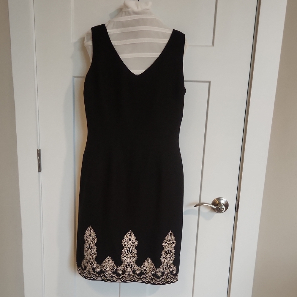 Positive Attitude: Classic black Sleeveless Dress with Embroidered Hem